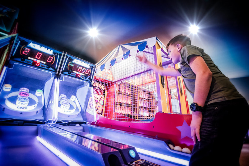 Young kid playing on arcade games