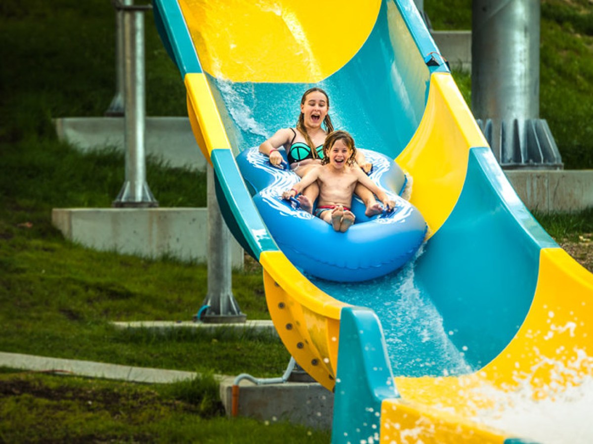 2 kids on a water slide