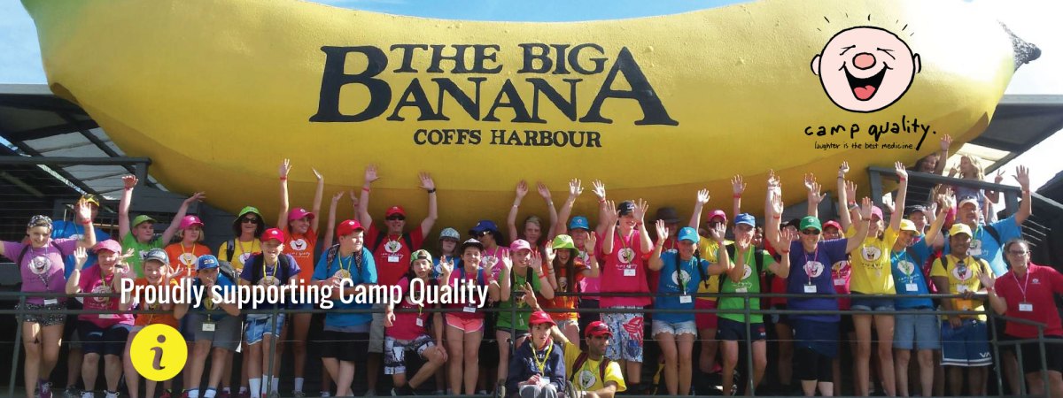 Group of people having photo with big banana