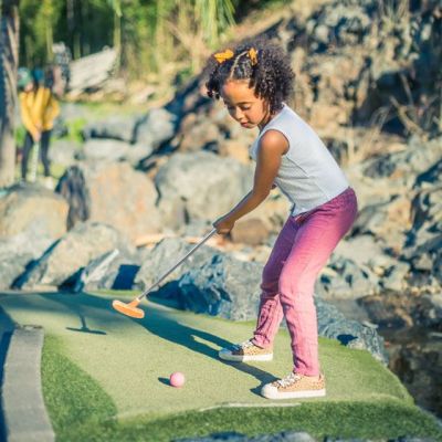 a young boy riding a skateboard up the side of the road