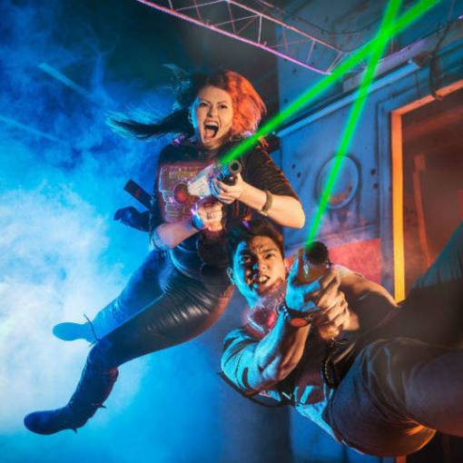 2 young people playing laser tag