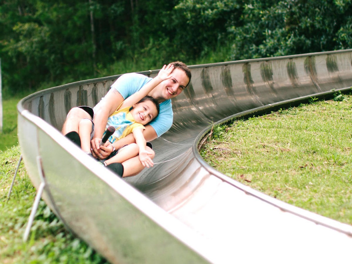 a person sitting on a bench in a park
