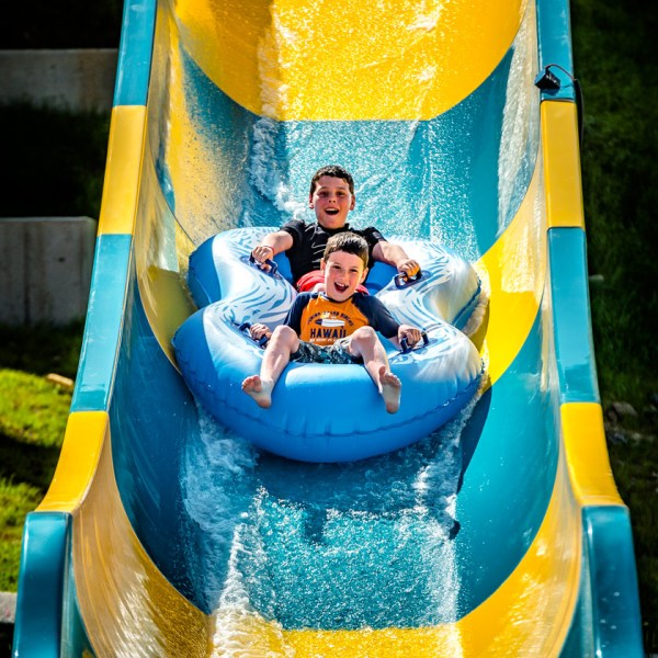 a train cake sitting on top of a blue wall