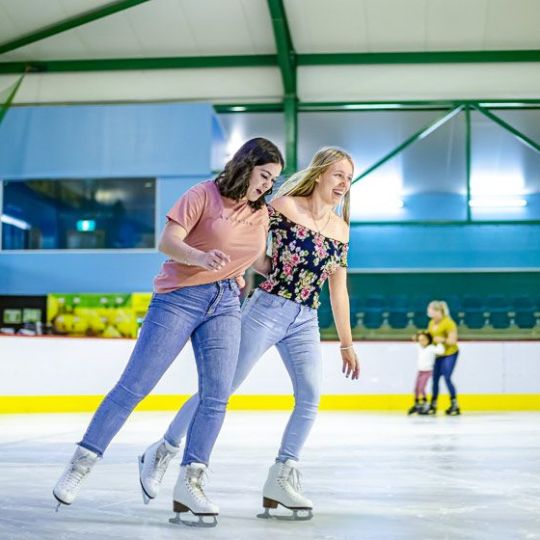 a woman riding skis down the side of a building