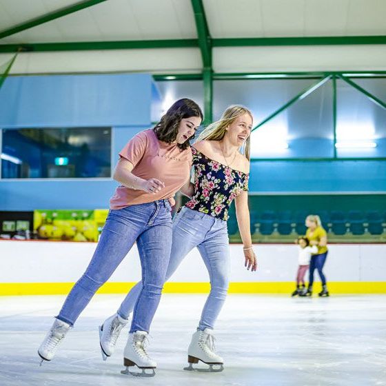 a woman riding skis down the side of a building