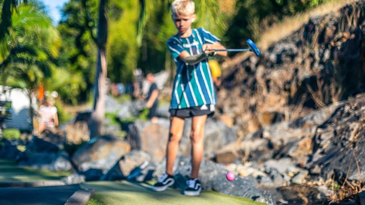 a little boy that is standing in the grass
