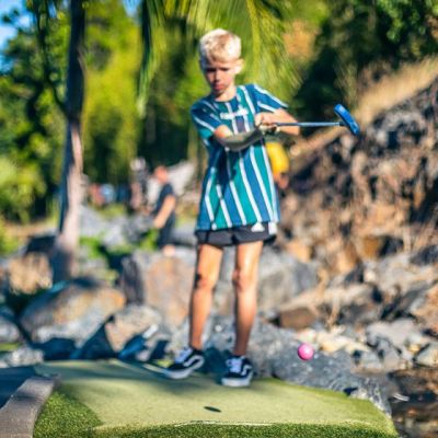 a little boy that is standing in the grass