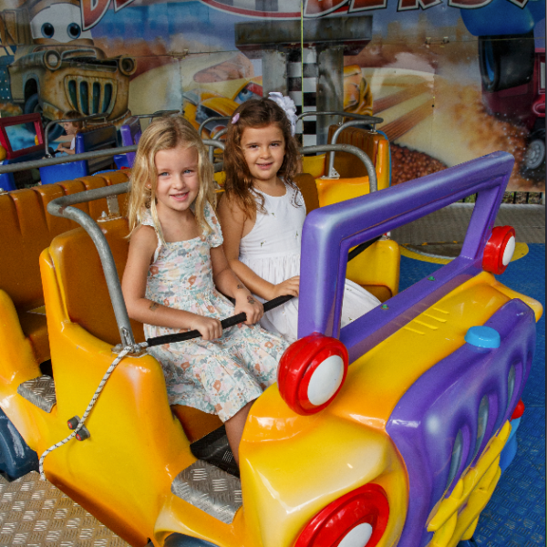 a little girl sitting on a motorcycle
