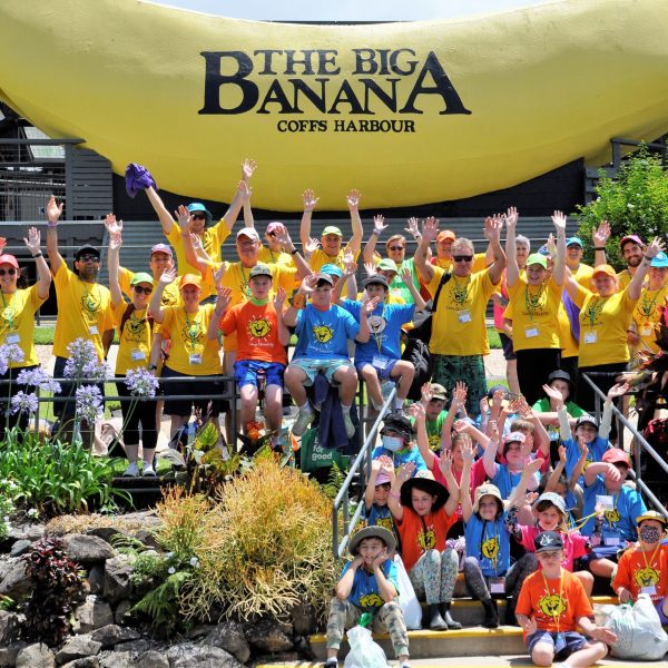 group of visitors with a big banana
