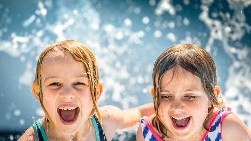 a little girl that is swimming in the water