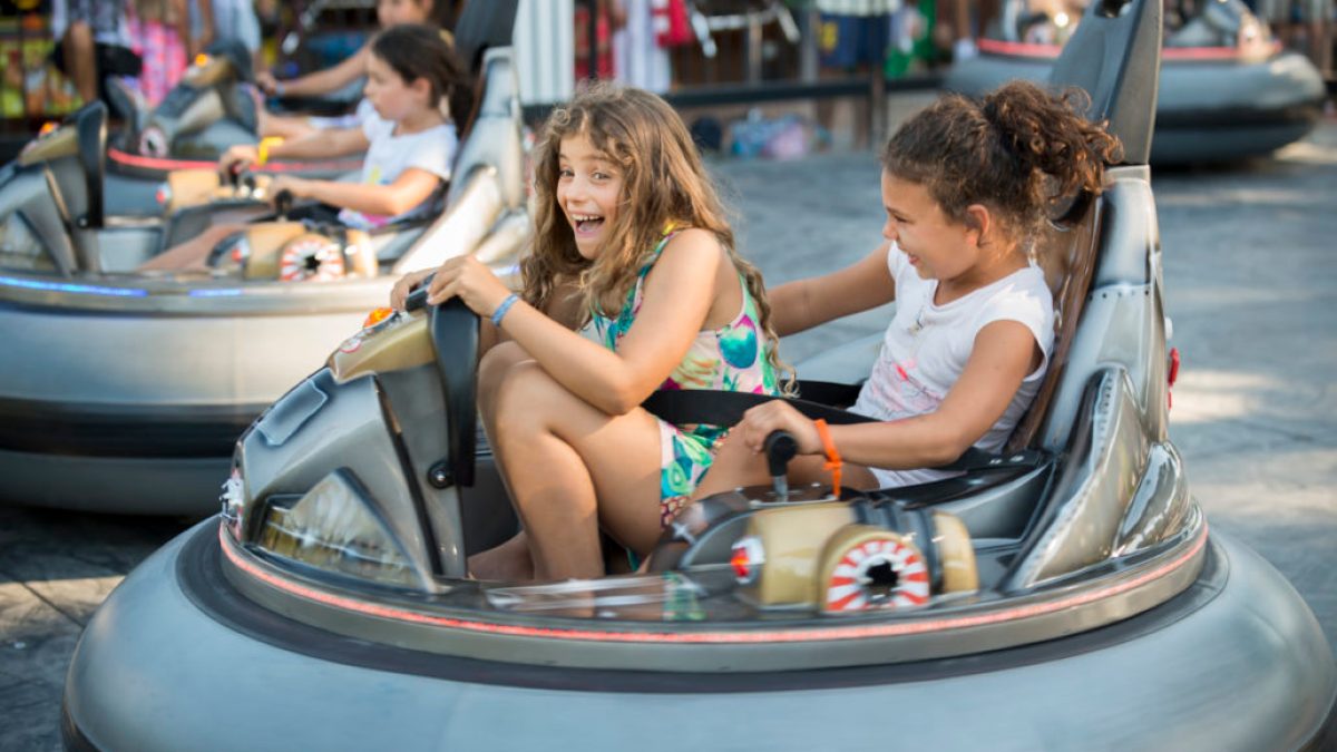 a little girl riding on the back of a boat