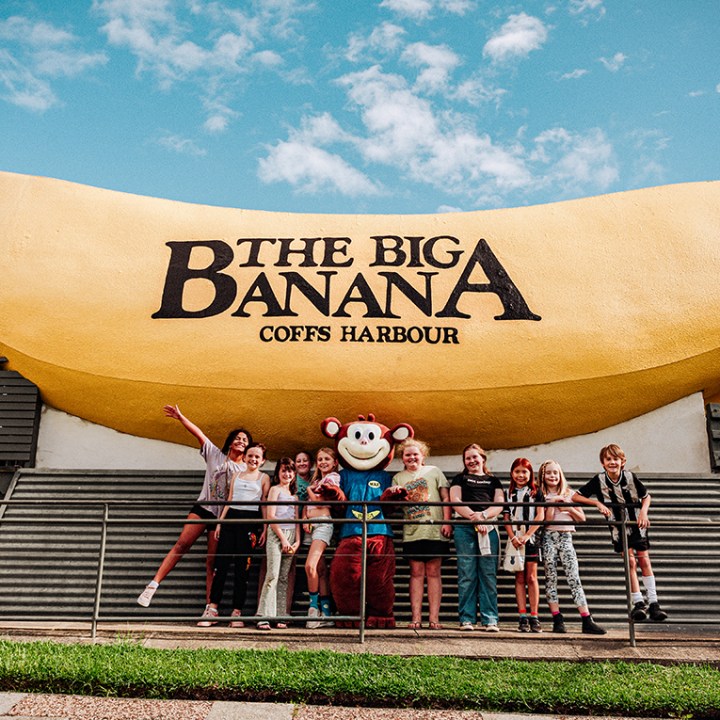 a sign on the side of a fence with Big Banana in the background